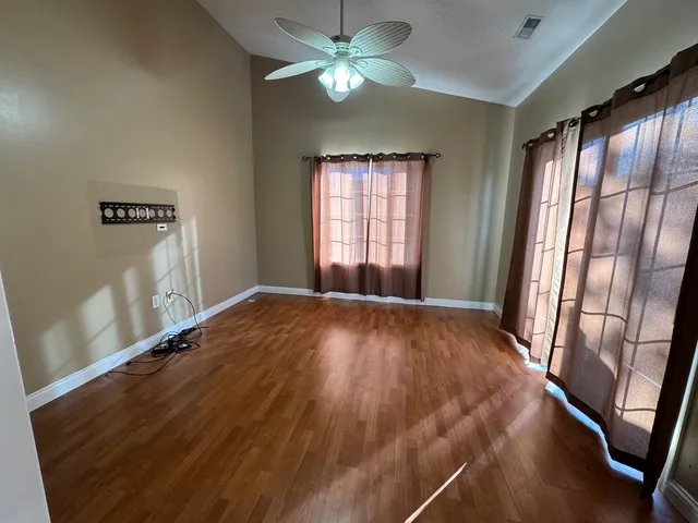 a view of an empty room and a window