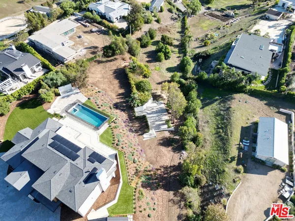 an aerial view of residential house with outdoor space and parking
