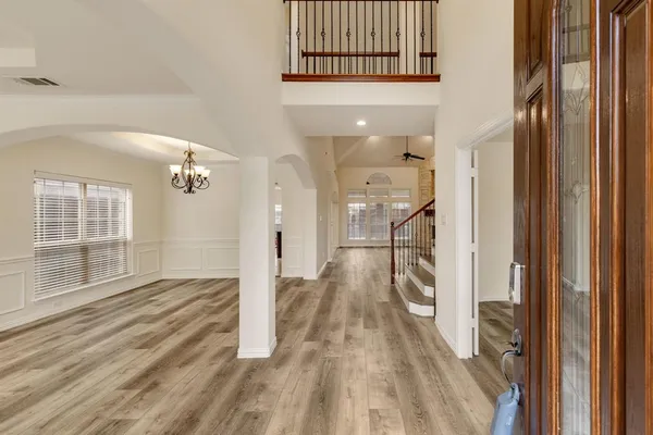 a view of a room with wooden floor and entryway