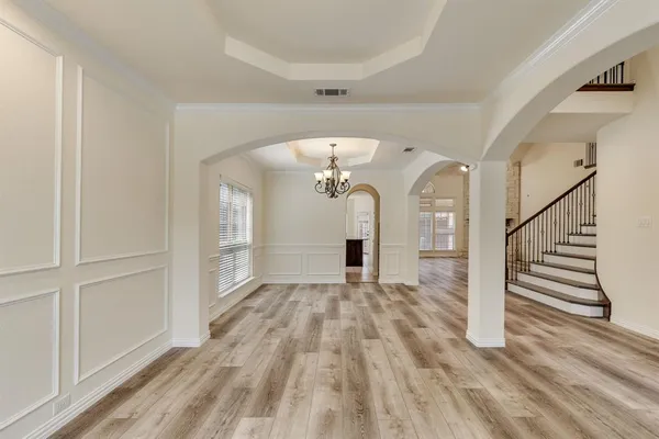 a view of a hallway with wooden floor and staircase