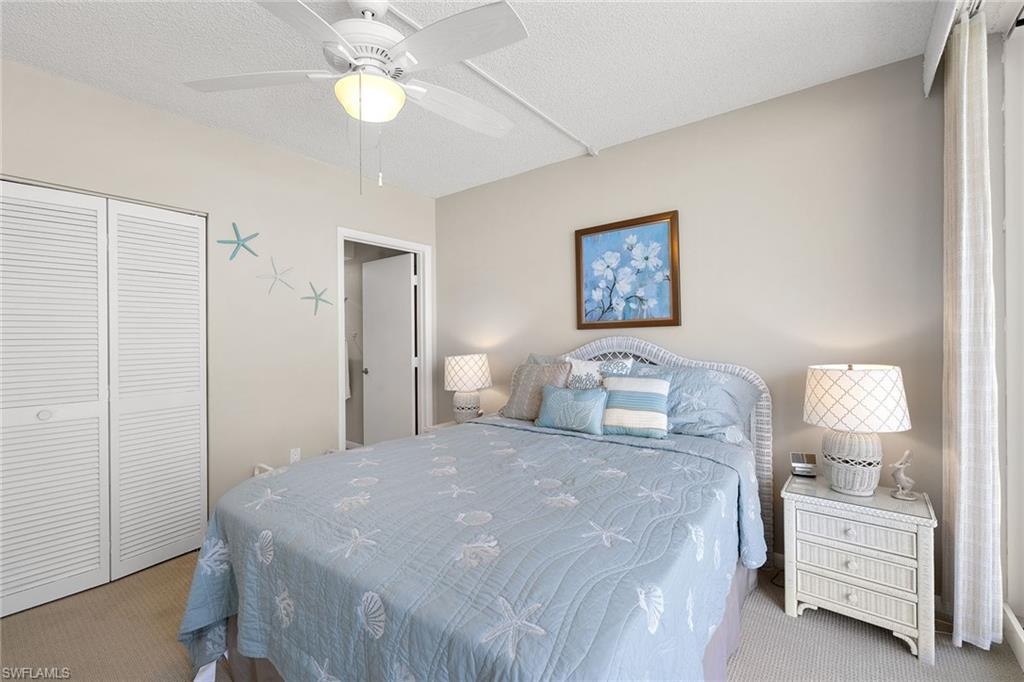 140 Seaview Court, Unit S902 Marco Island, FL 34145 - Photo 11 of 24 a bedroom with a bed and a lamp on dresser