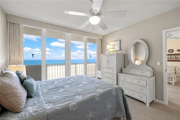a spacious bedroom with a large bed and a dresser