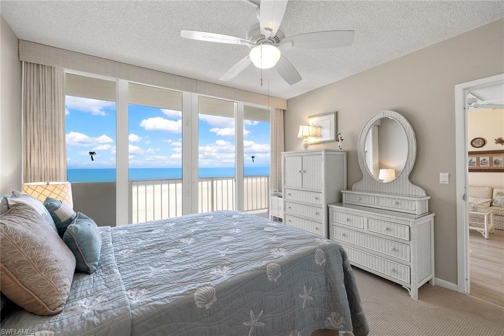 140 Seaview Court, Unit S902 Marco Island, FL 34145 - Photo 12 of 24 a spacious bedroom with a large bed and a dresser