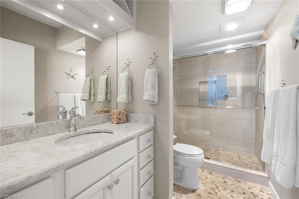 140 Seaview Court, Unit S902 Marco Island, FL 34145 - Photo 13 of 24 a bathroom with a granite countertop sink toilet and shower