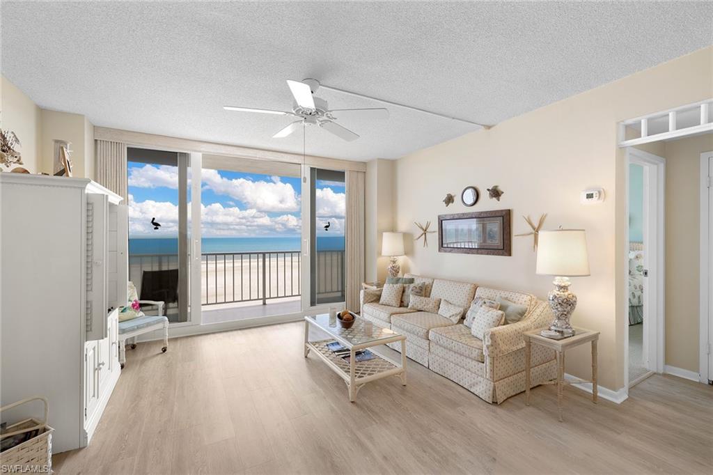 140 Seaview Court, Unit S902 Marco Island, FL 34145 - Photo 2 of 24 a living room with furniture and a large window
