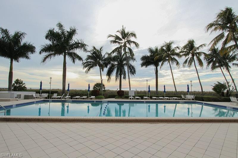 140 Seaview Court, Unit S902 Marco Island, FL 34145 - Photo 21 of 24 a view of swimming pool with a table and chairs