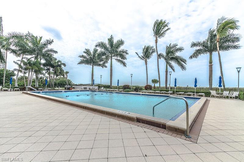 140 Seaview Court, Unit S902 Marco Island, FL 34145 - Photo 22 of 24 a view of swimming pool with outdoor seating and palm trees