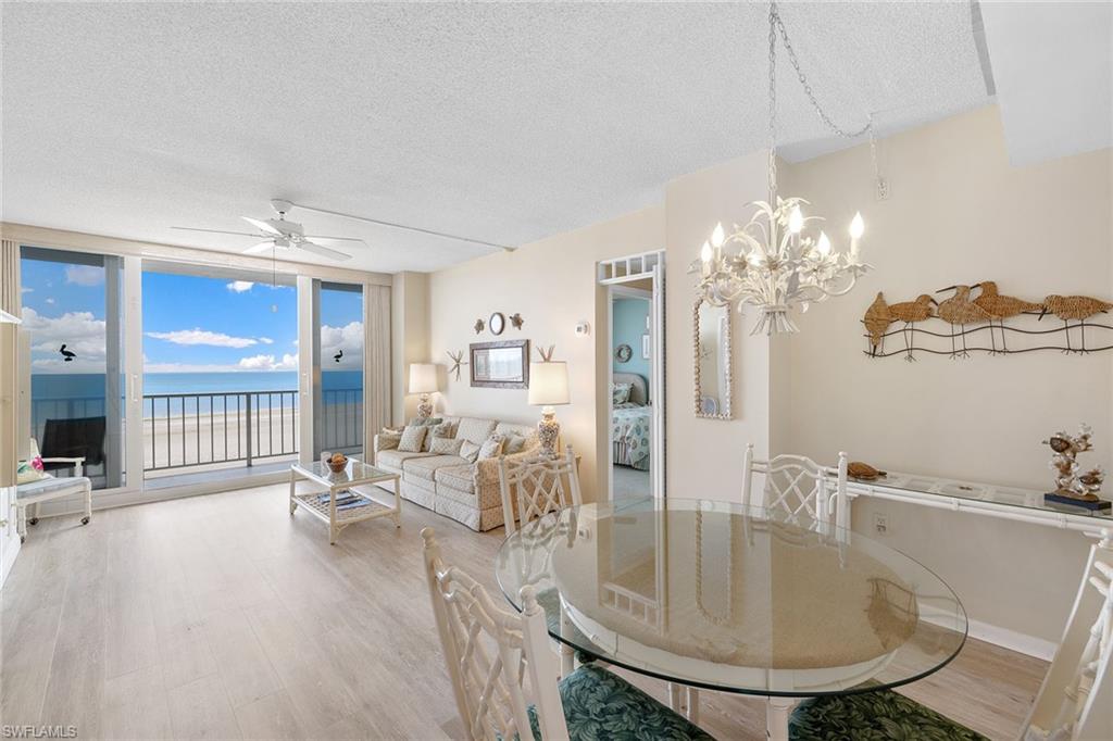 140 Seaview Court, Unit S902 Marco Island, FL 34145 - Photo 8 of 24 a dining room with furniture a chandelier and window