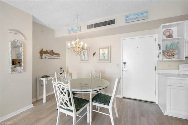 a dining room with furniture and chandelier