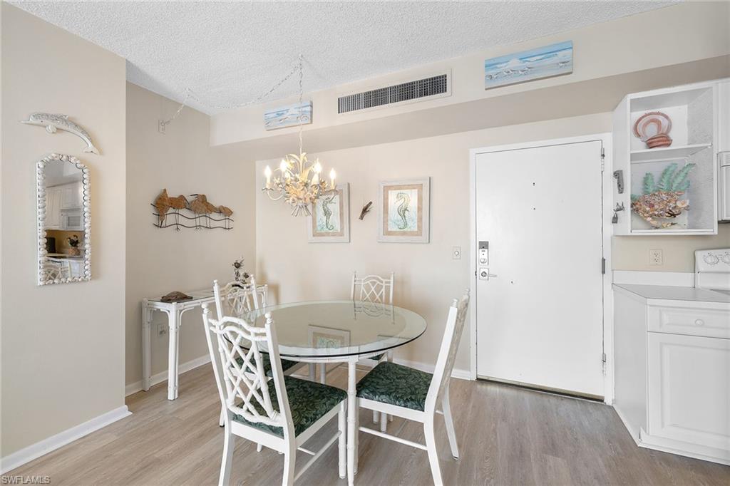 140 Seaview Court, Unit S902 Marco Island, FL 34145 - Photo 9 of 24 a dining room with furniture and chandelier