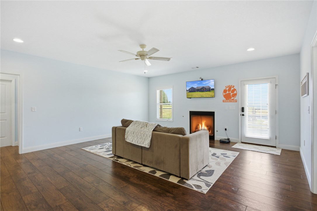426 Oak Creek Road Seneca, SC 29678 - Photo 21 of 50 Warm and inviting living space with rich hardwood floors and a cozy fireplace.