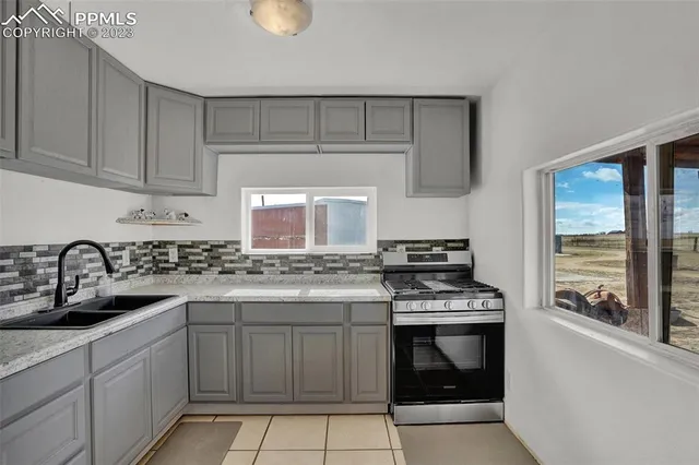 a kitchen with white cabinets and appliances
