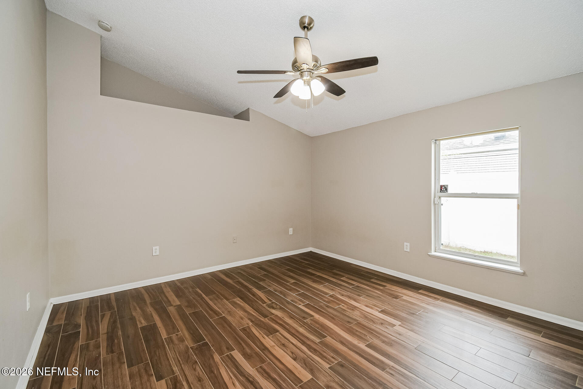 7319 Wood Duck Road Jacksonville, FL 32244 - Photo 13 of 21 wooden floor in an empty room with a window