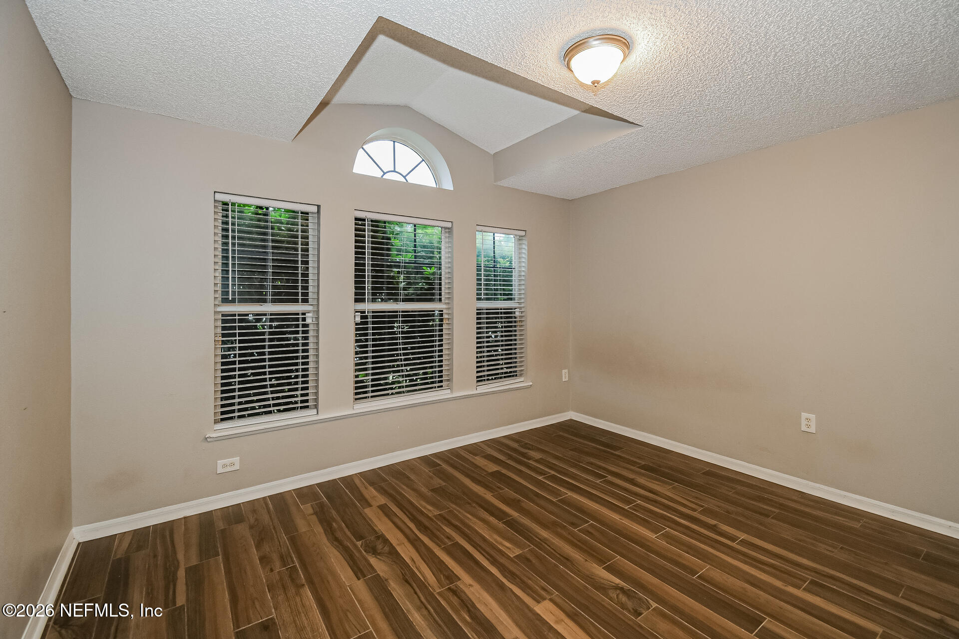 7319 Wood Duck Road Jacksonville, FL 32244 - Photo 16 of 21 a view of an empty room with wooden floor and a window