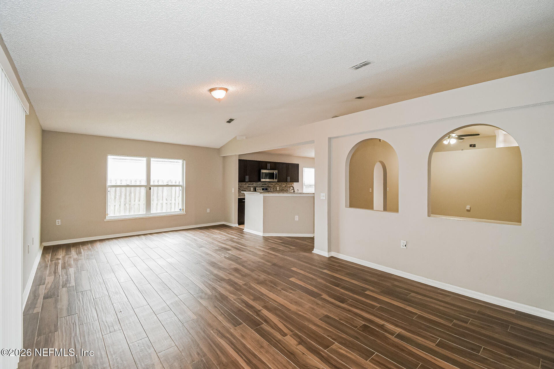 7319 Wood Duck Road Jacksonville, FL 32244 - Photo 3 of 21 wooden floor in an empty room with a window