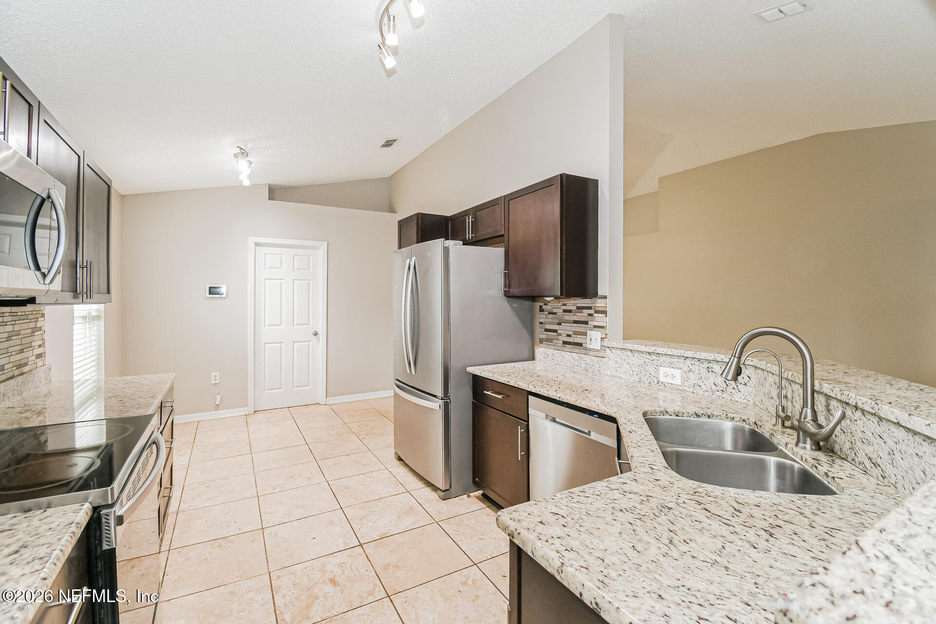 7319 Wood Duck Road Jacksonville, FL 32244 - Photo 9 of 21 a kitchen with stainless steel appliances granite countertop a sink a stove and refrigerator