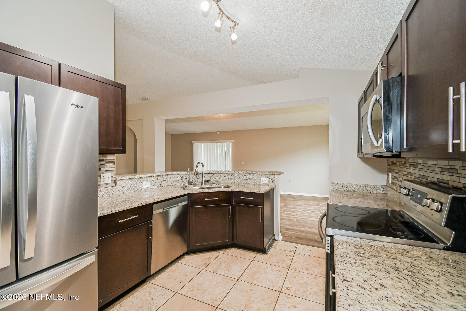 7319 Wood Duck Road Jacksonville, FL 32244 - Photo 10 of 21 a kitchen with stainless steel appliances granite countertop a stove a sink and a refrigerator