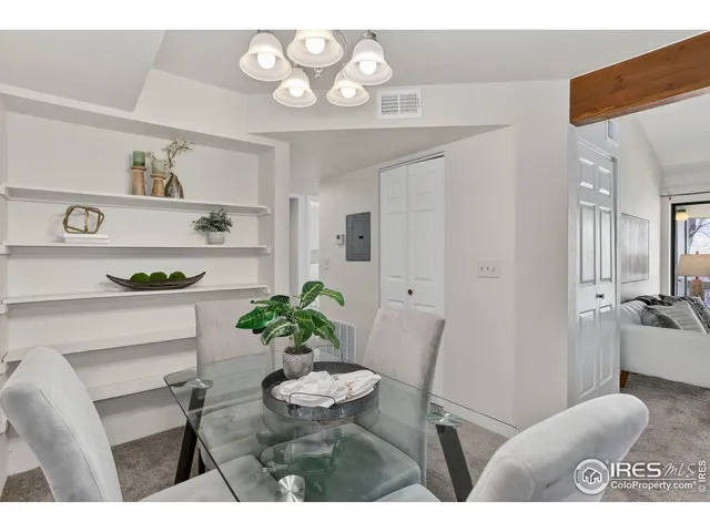 a living room with furniture and a dining table
