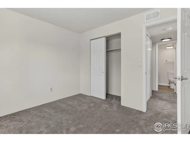 a view of an empty room and closet