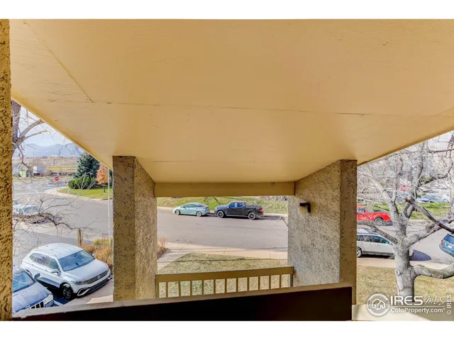 a view of a cars park in front of a building