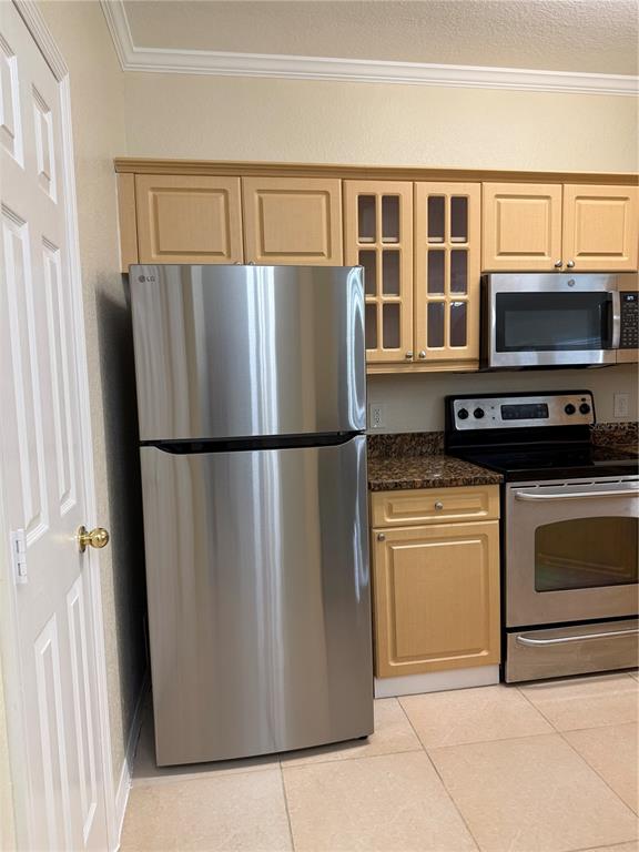3725 Conroy Road, Unit 2127 Orlando, FL 32839 - Photo 11 of 30 a kitchen with stainless steel appliances granite countertop a refrigerator and a stove top oven