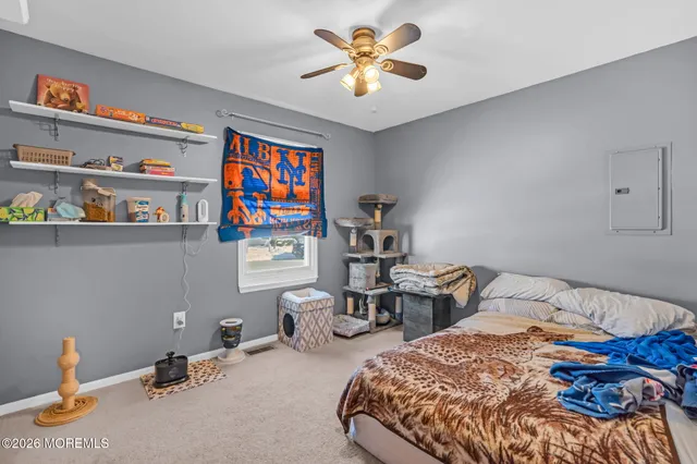 a bedroom with bed and a chandelier
