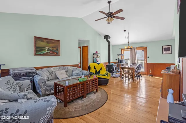 a living room with furniture kitchen view and a chandelier