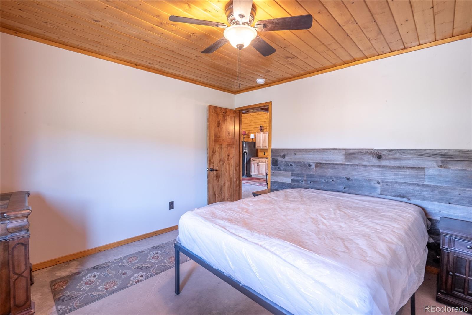0 Picketwire Road Trinidad, CO 81082 - Photo 17 of 39 a spacious bedroom with a bed and a chandelier