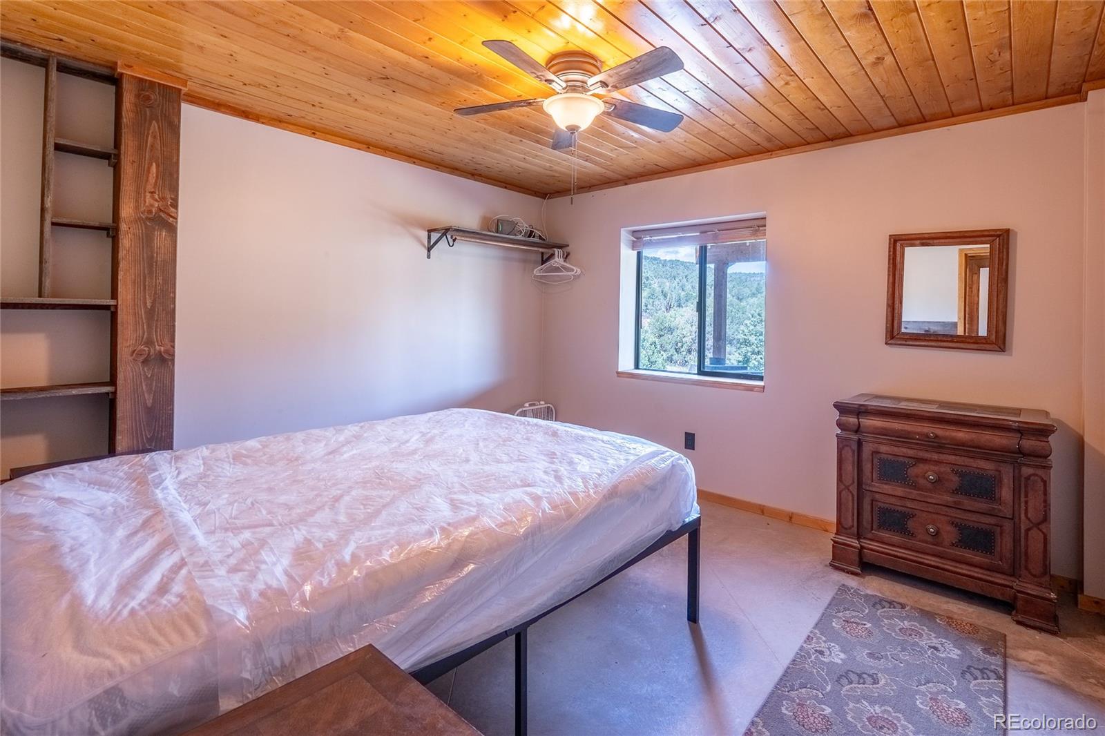 0 Picketwire Road Trinidad, CO 81082 - Photo 18 of 39 a bedroom with a bed and a chandelier