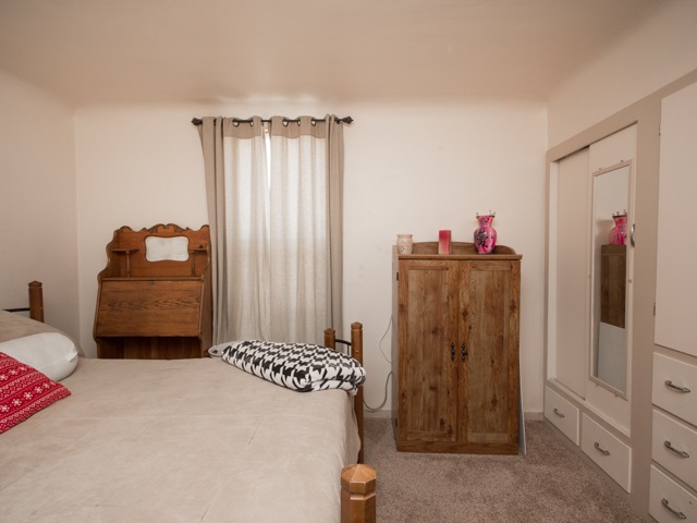 1102 21 Road Grand Junction, CO 81505 - Photo 6 of 20 a bedroom with a bed and a refrigerator