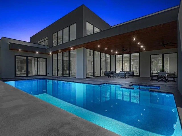 a swimming pool with outdoor seating