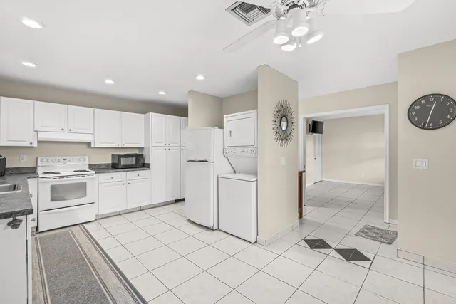 a kitchen with white cabinets and white appliances