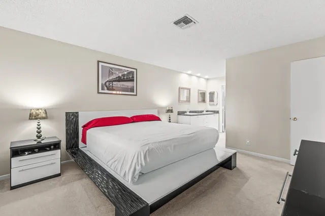 a bedroom with a bed and a lamp