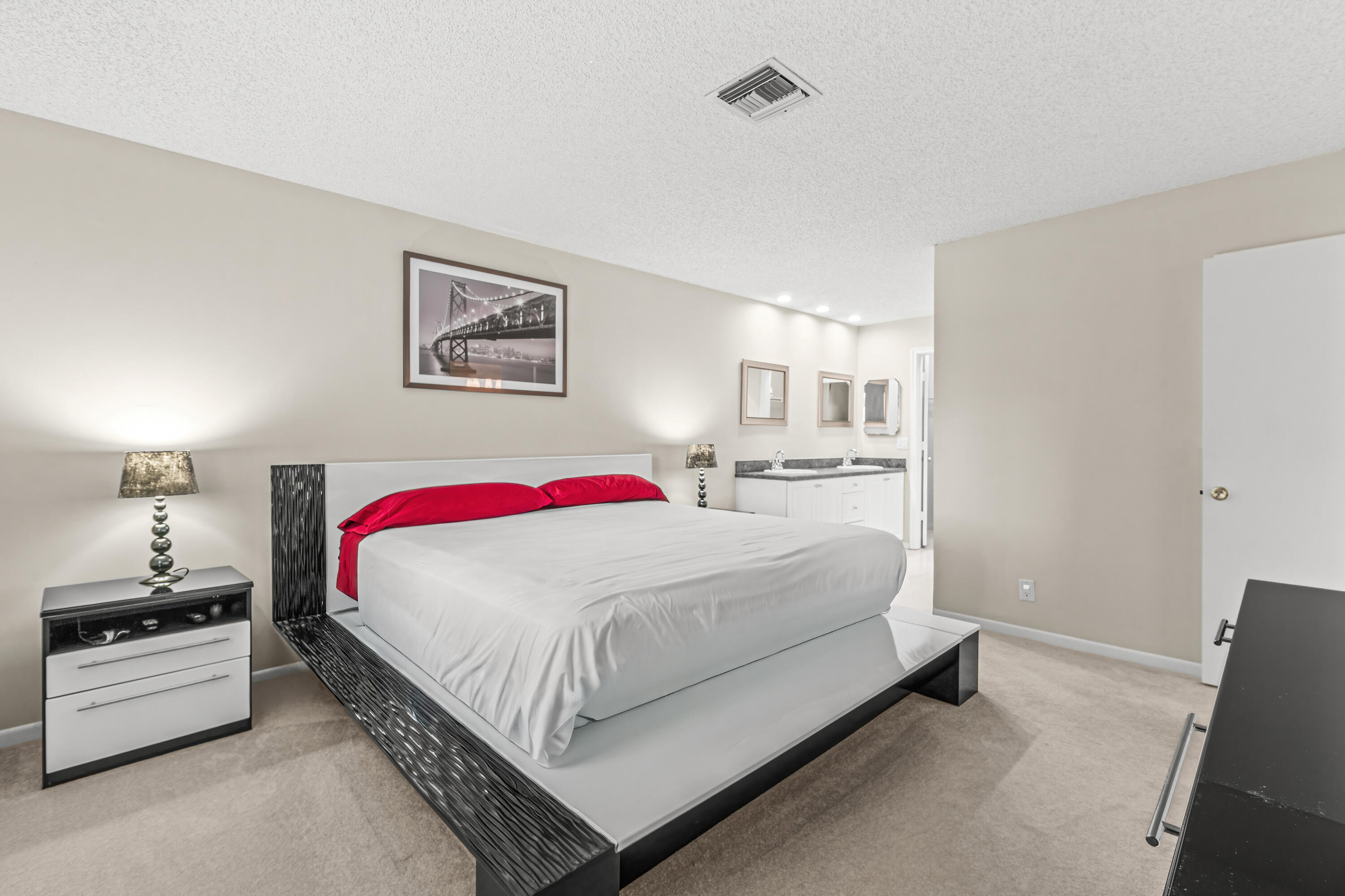 1521 Northwest 19th Terrace, Unit 202 Delray Beach, FL 33445 - Photo 18 of 32 a bedroom with a bed and a lamp