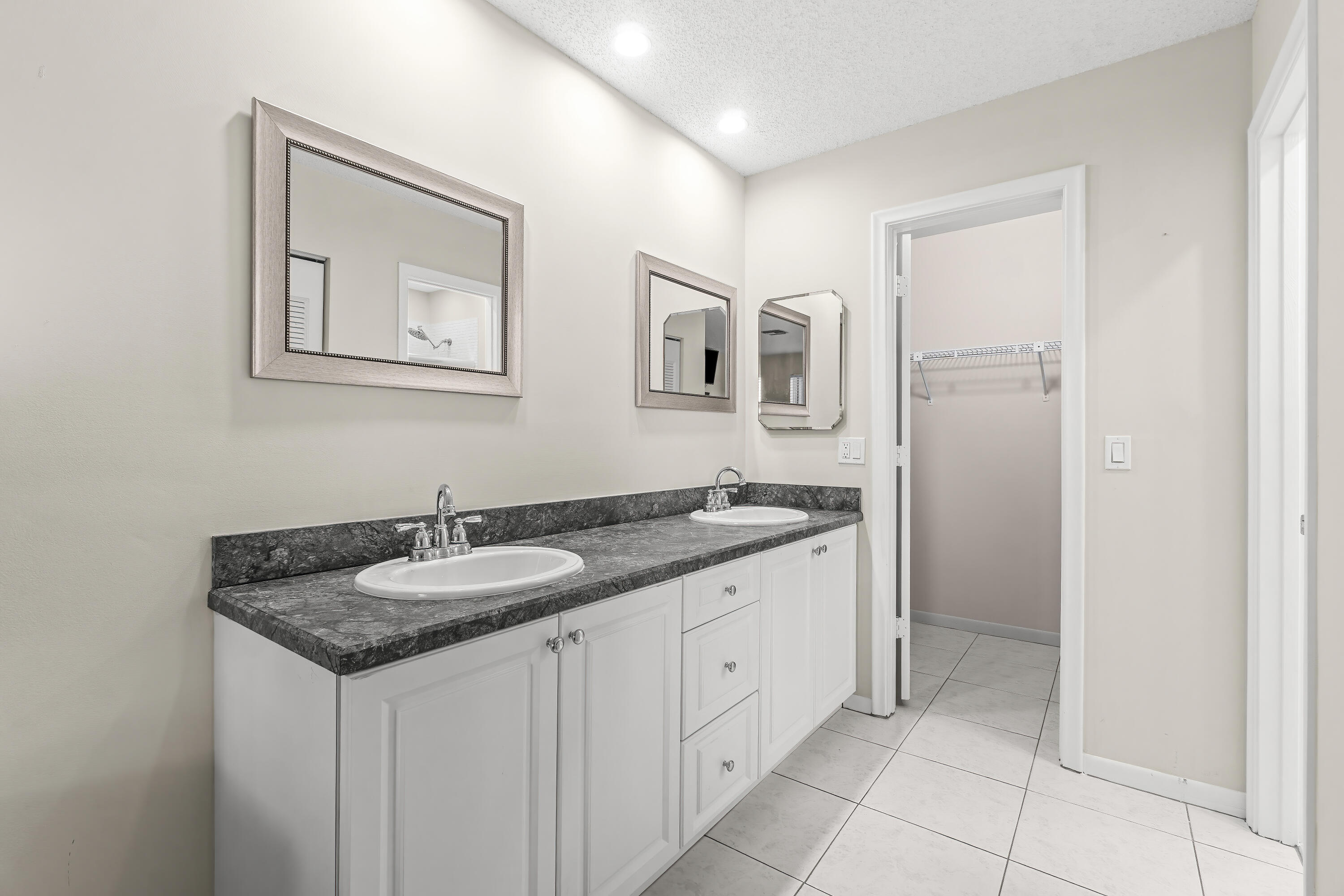 1521 Northwest 19th Terrace, Unit 202 Delray Beach, FL 33445 - Photo 20 of 32 a bathroom with a granite countertop sink and a mirror