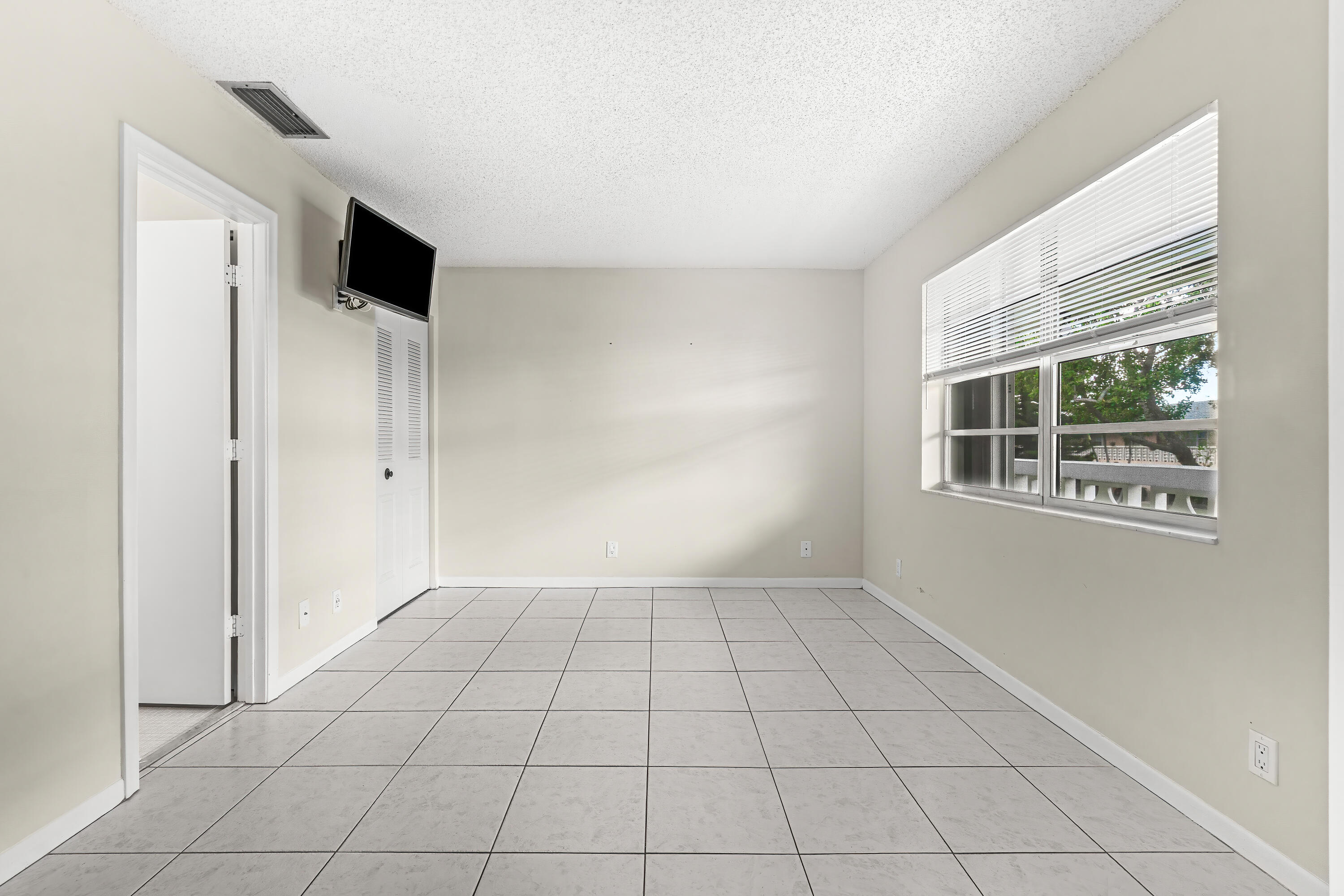 1521 Northwest 19th Terrace, Unit 202 Delray Beach, FL 33445 - Photo 25 of 32 a view of an empty room with a window