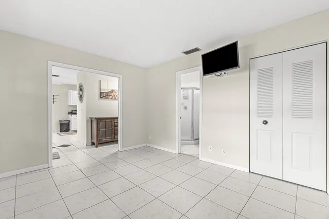 a view of a livingroom with an empty space and a window