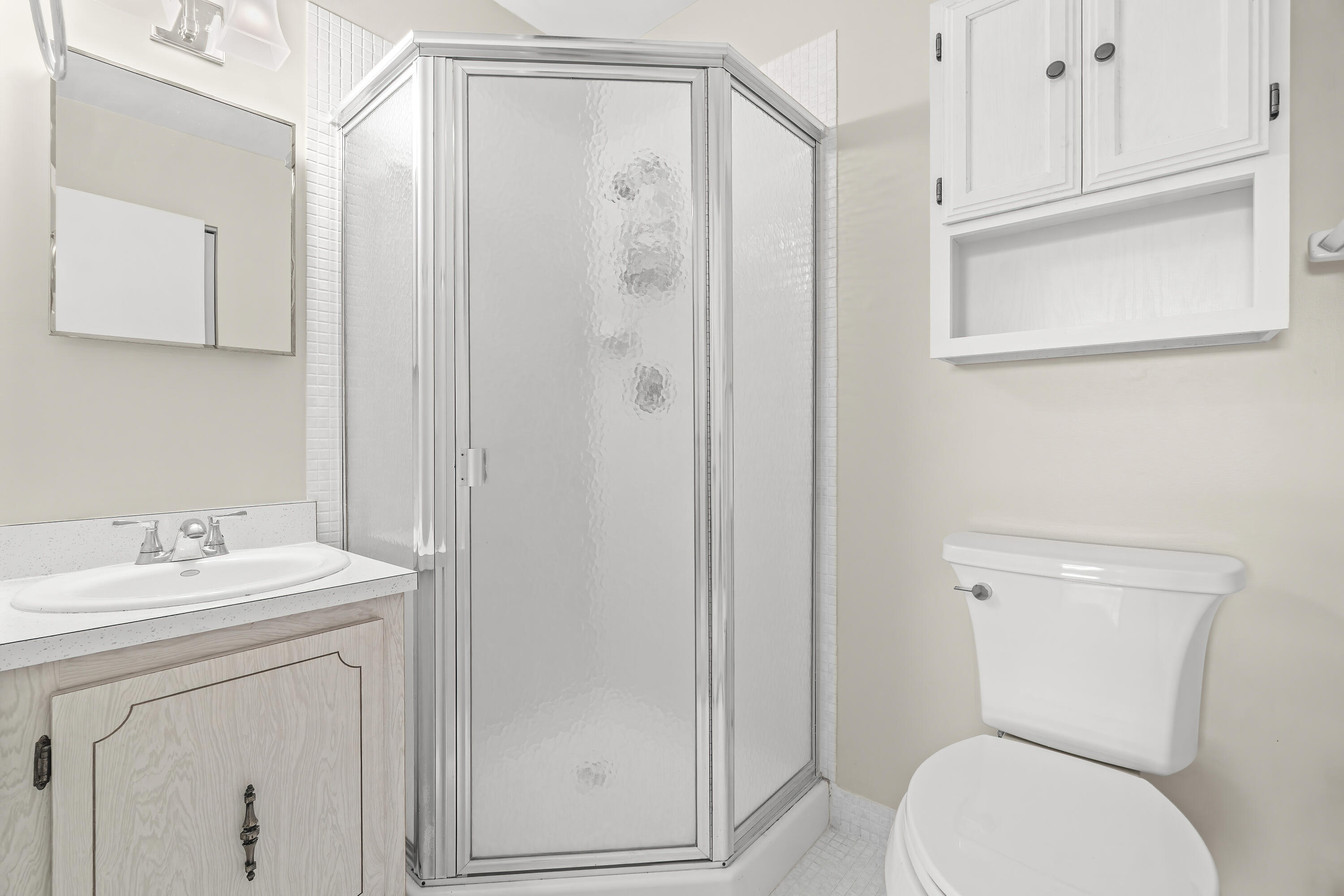 1521 Northwest 19th Terrace, Unit 202 Delray Beach, FL 33445 - Photo 27 of 32 a bathroom with a toilet a sink a vanity and mirror