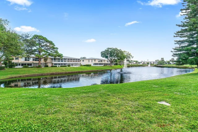 a view of a lake with houses in the background