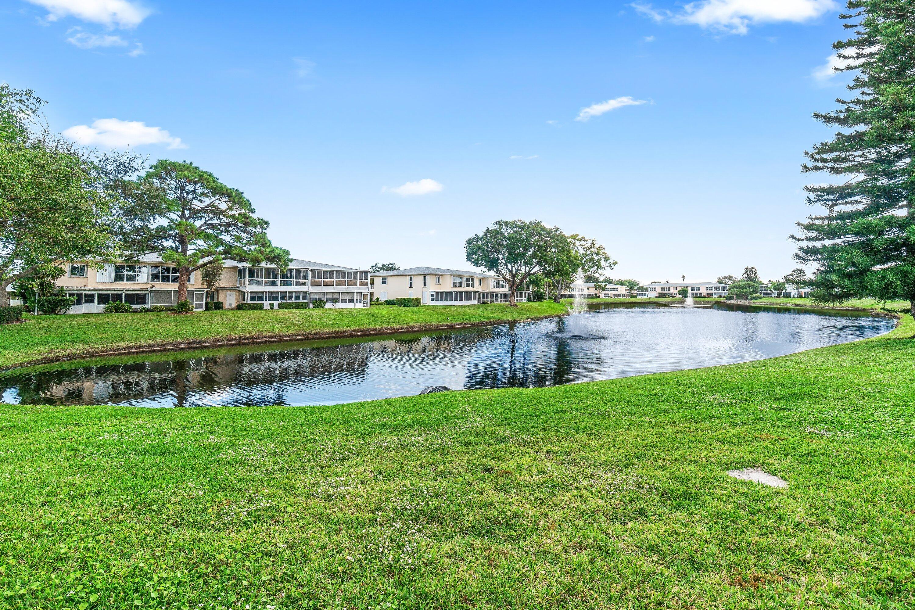 1521 Northwest 19th Terrace, Unit 202 Delray Beach, FL 33445 - Photo 31 of 32 a view of a lake with houses in the background