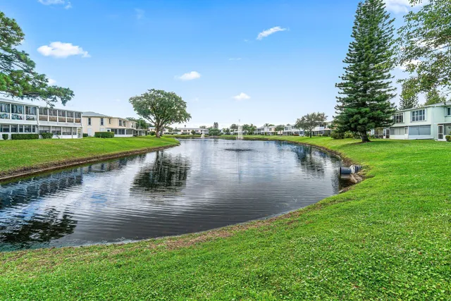 a view of a lake with houses in the back