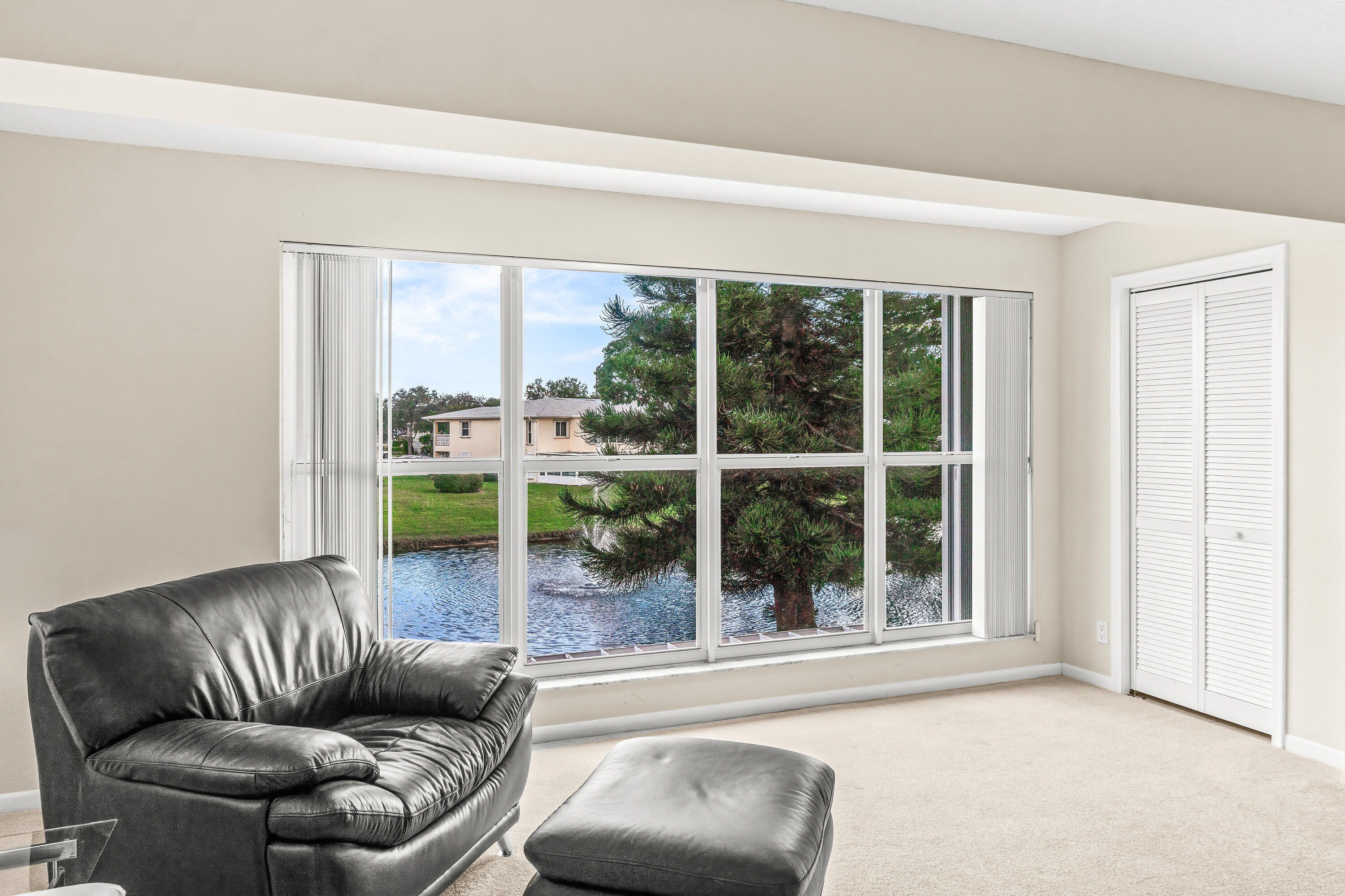 1521 Northwest 19th Terrace, Unit 202 Delray Beach, FL 33445 - Photo 5 of 32 a living room with furniture and a large window