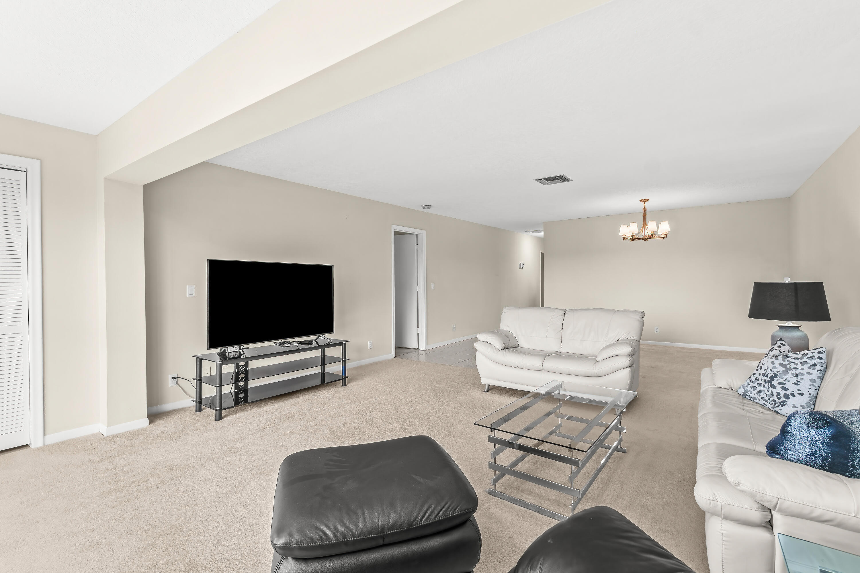 1521 Northwest 19th Terrace, Unit 202 Delray Beach, FL 33445 - Photo 6 of 32 a living room with furniture and a flat screen tv