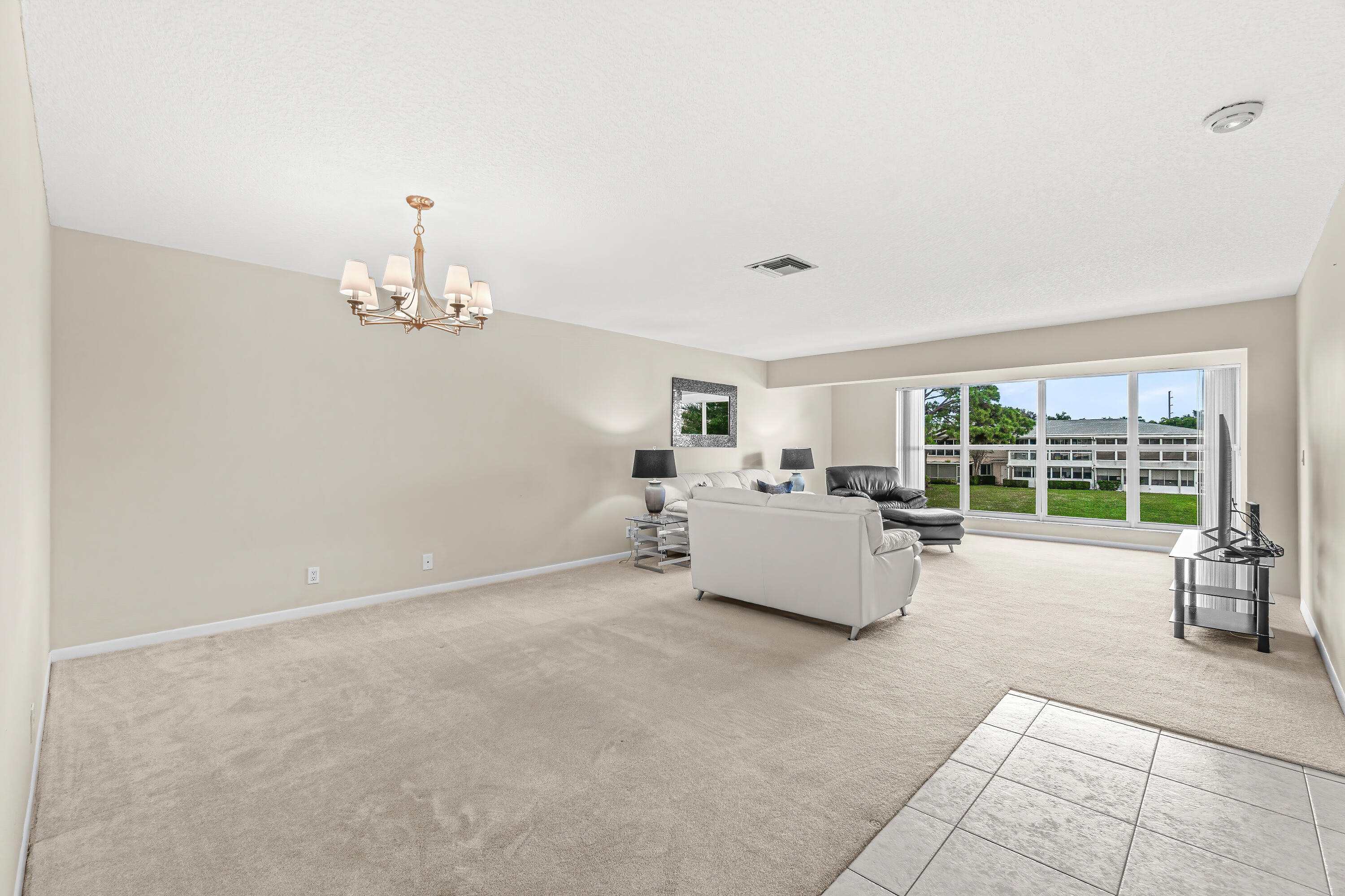 1521 Northwest 19th Terrace, Unit 202 Delray Beach, FL 33445 - Photo 9 of 32 a living room with furniture and a table