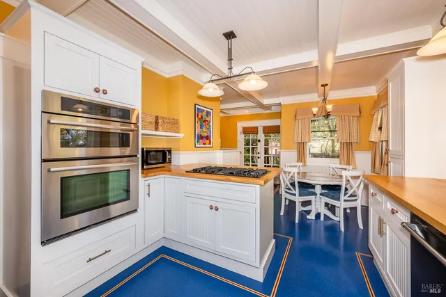 a kitchen with stainless steel appliances a stove a sink and a refrigerator