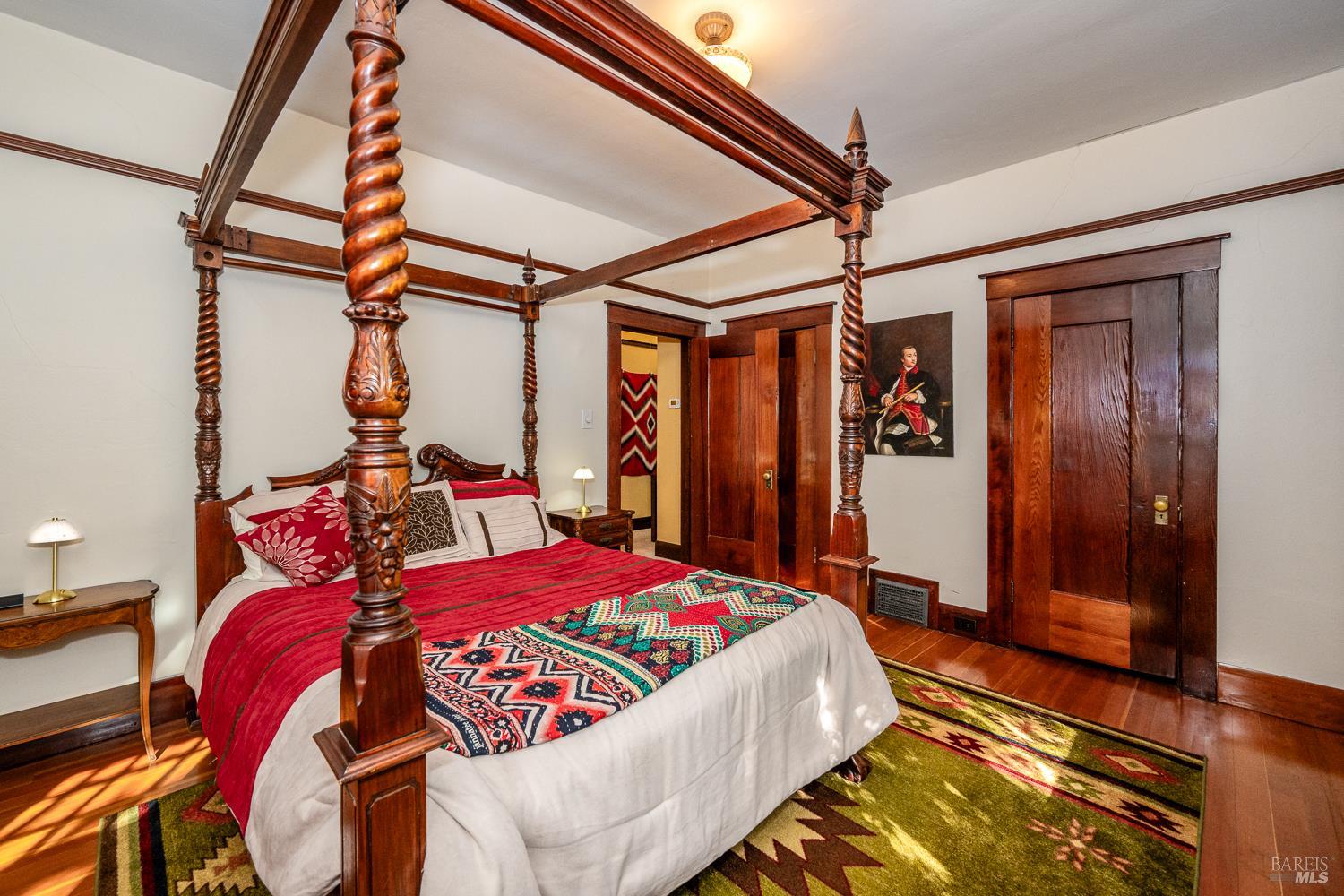 721 Spring Street Santa Rosa, CA 95404 - Photo 16 of 32 a bedroom with a large bed and a chandelier