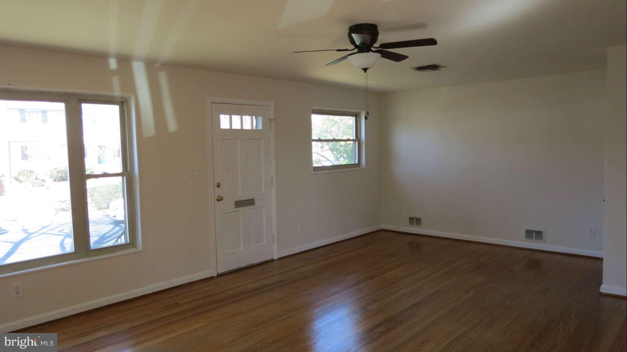 2401 Cameron Mills Road Alexandria, VA 22302 - Photo 3 of 30 a view of empty room with wooden floor and fan