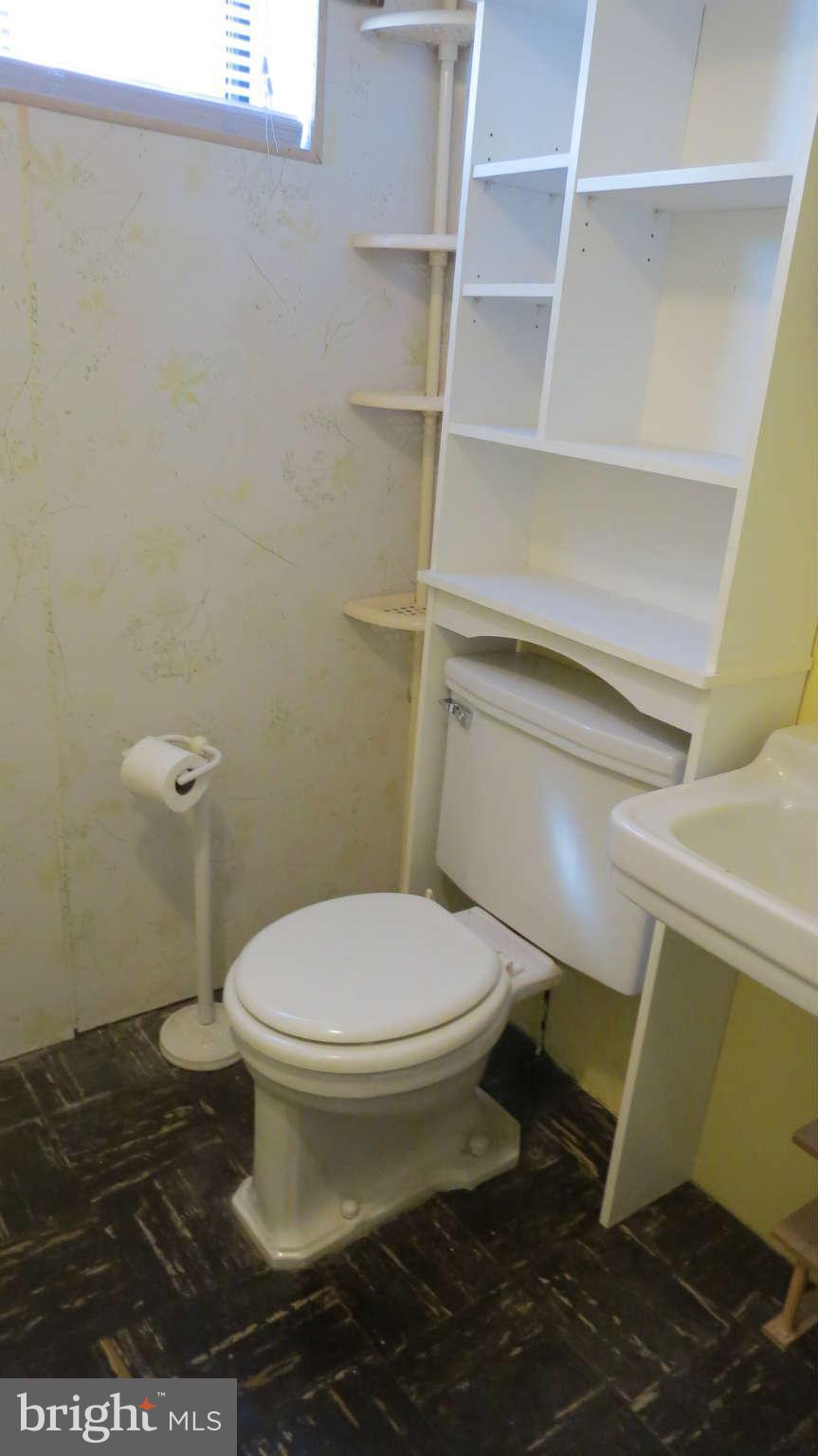 2401 Cameron Mills Road Alexandria, VA 22302 - Photo 22 of 30 a white toilet sitting next to a sink