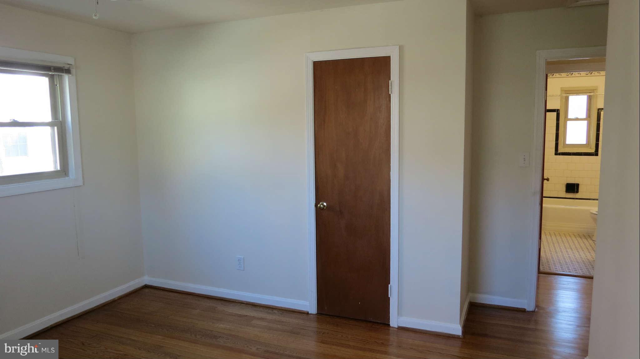 2401 Cameron Mills Road Alexandria, VA 22302 - Photo 8 of 30 a view of an empty room with wooden floor and a window