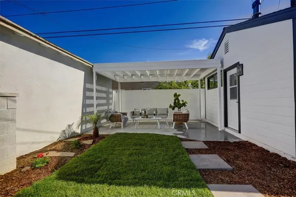 a view of a patio with table and chairs potted plants with wooden floor